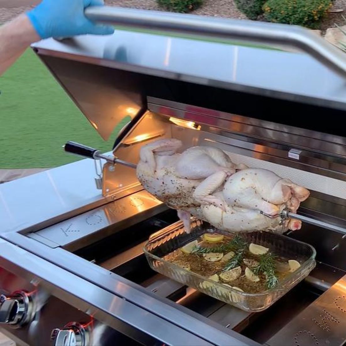 Prepping the chicken inside the Kokomo 32” Professional 4-Burner Built-in Gas Grill